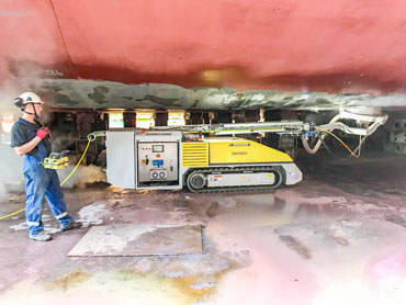 Dockboy surface preparation machine removing paint from the underside of a ship.