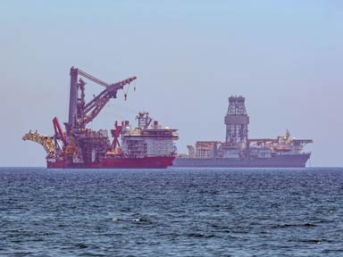 Offshore drilling ship and pipe layer ship anchored near Limassol coast, Cyprus