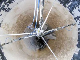 The inside of a tank being cleaned using high pressure water.