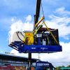 A pump skid being lifted into position at an exhibition.